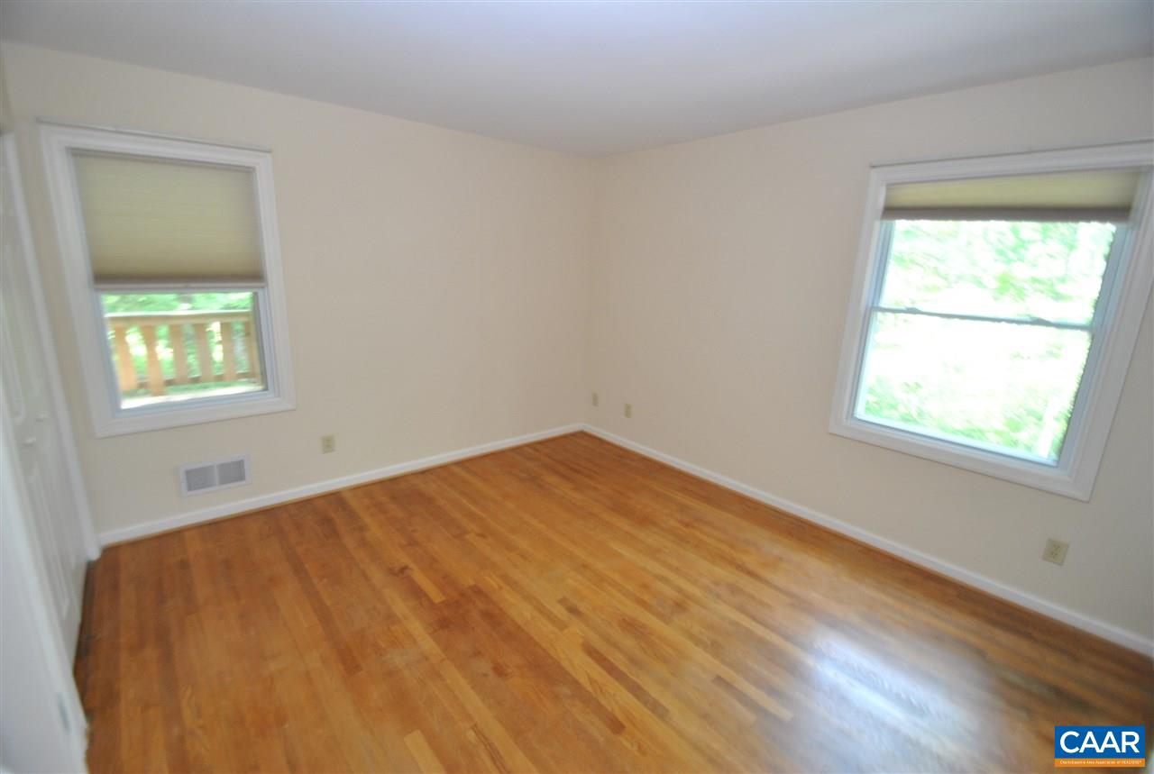 114 Elkhorn Road Charlottesville, VA 22903 - Photo 19 of 23 a view of an empty room with wooden floor and a window