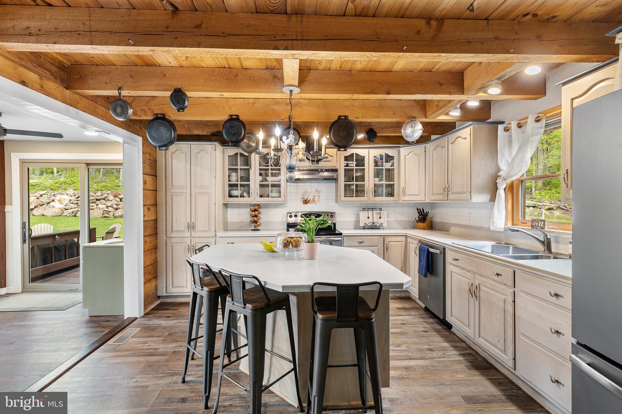 491 Sheep Hill Road Newmanstown, PA 17073 - Photo 13 of 30 a kitchen with stainless steel appliances a dining table chairs and white cabinets
