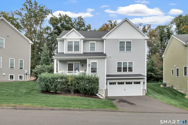 a front view of a house with a garden