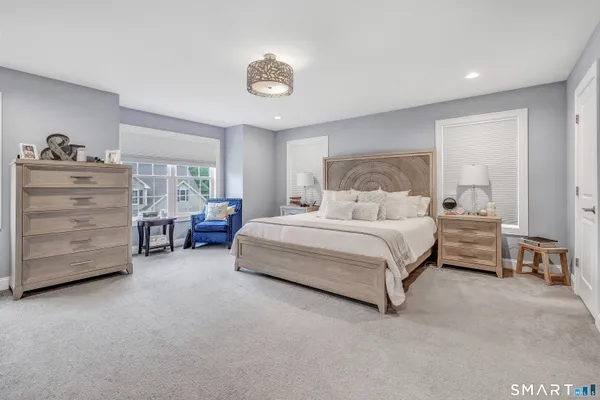 a bedroom with a bed and a couch