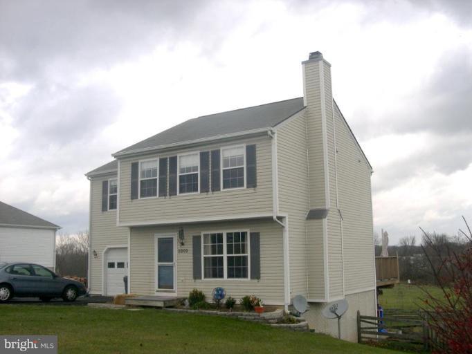 3202 Atlee Ridge Road New Windsor, MD 21776 - Photo 1 of 19 a view of a house with a backyard