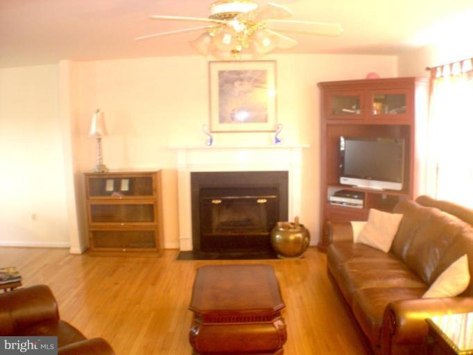 3202 Atlee Ridge Road New Windsor, MD 21776 - Photo 2 of 19 a living room with furniture and a fireplace