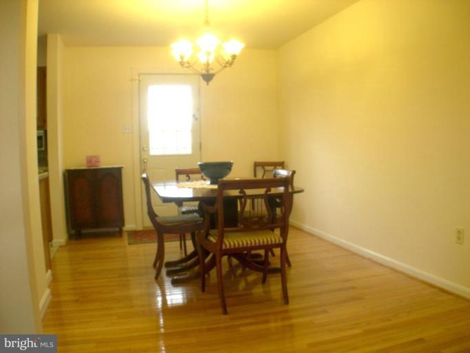 3202 Atlee Ridge Road New Windsor, MD 21776 - Photo 3 of 19 a view of a dining room with furniture and a chandelier