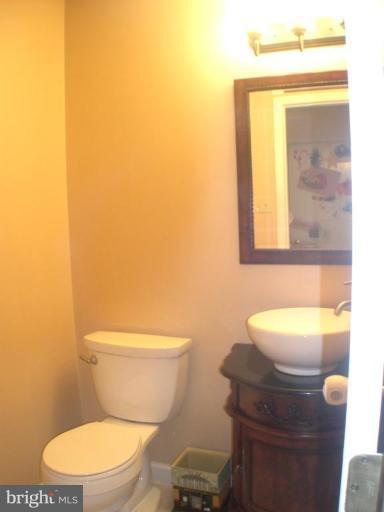3202 Atlee Ridge Road New Windsor, MD 21776 - Photo 10 of 19 a bathroom with a toilet a sink and mirror