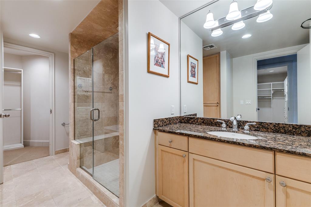 1505 Elm Street, Unit 1401 Dallas, TX 75201 - Photo 14 of 35 a bathroom with a granite countertop sink mirror and shower