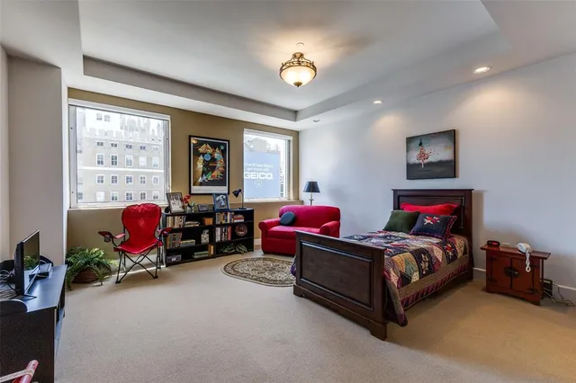 a bedroom with bed and a large window