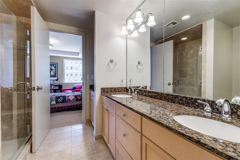 1505 Elm Street, Unit 1401 Dallas, TX 75201 - Photo 19 of 35 a en suite bathroom with a sink and a mirror