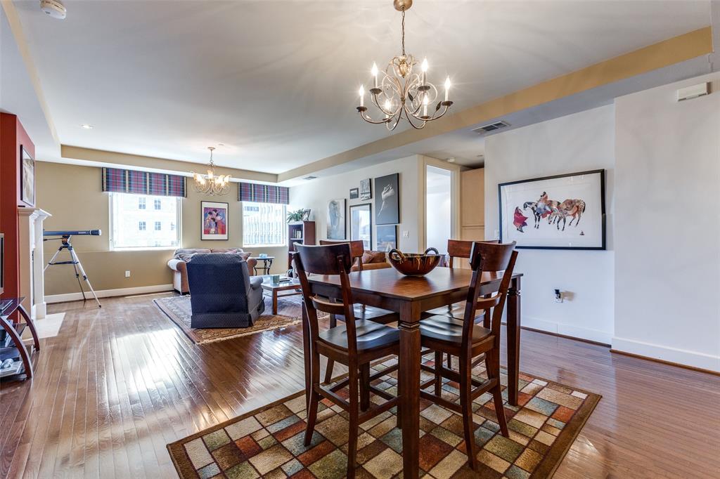 1505 Elm Street, Unit 1401 Dallas, TX 75201 - Photo 4 of 35 a view of a dining room with furniture a chandelier and wooden floor