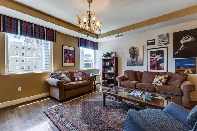 a living room with furniture and a chandelier
