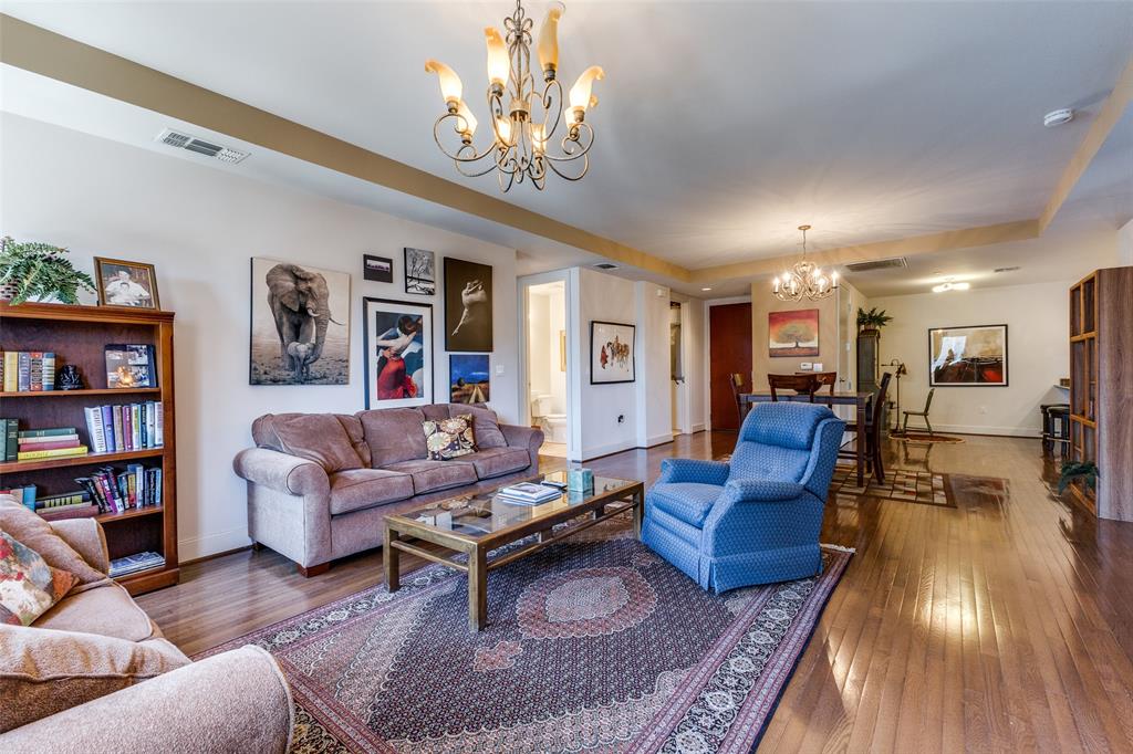 1505 Elm Street, Unit 1401 Dallas, TX 75201 - Photo 6 of 35 a living room with furniture or couch and a bookshelf