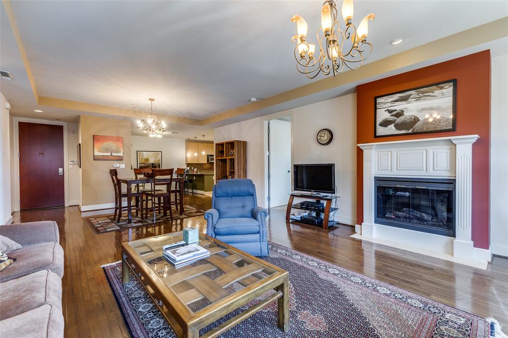 1505 Elm Street, Unit 1401 Dallas, TX 75201 - Photo 7 of 35 a living room with furniture a fireplace and a chandelier