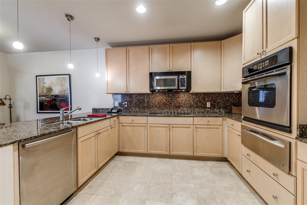1505 Elm Street, Unit 1401 Dallas, TX 75201 - Photo 10 of 35 a kitchen with stainless steel appliances granite countertop a sink and a microwave