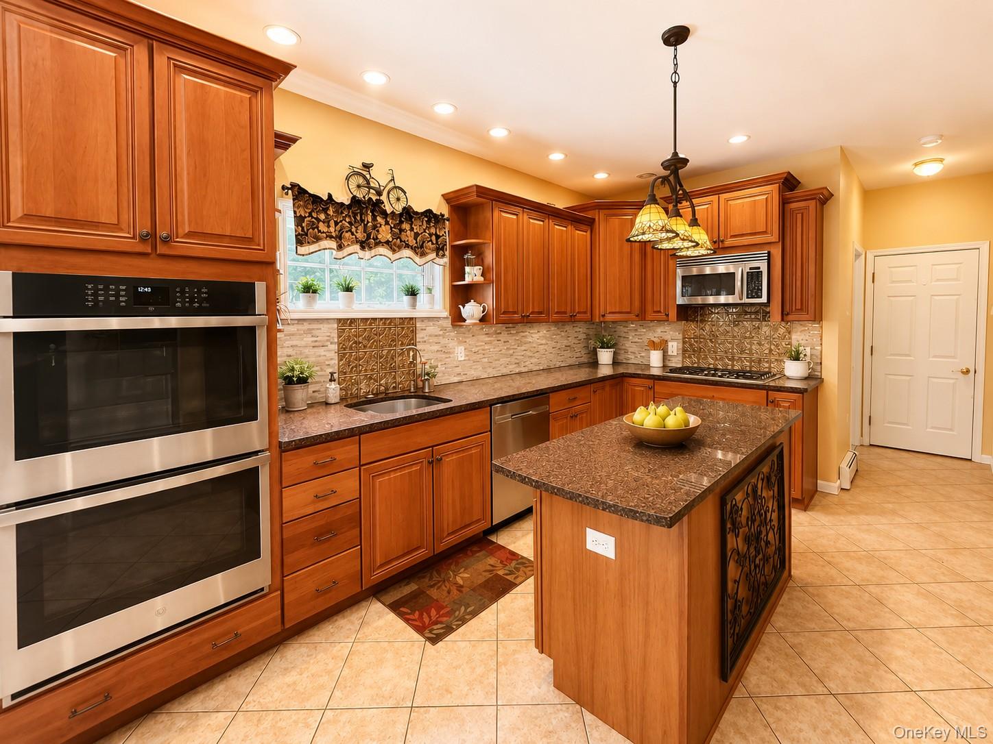 411 Mt Joy Road Middletown, NY 10941 - Photo 36 of 49 Kitchen featuring wood cabinetry, stainless steel double wall ovens, a central island with a granite-style countertop, a tile backsplash, and recessed lighting