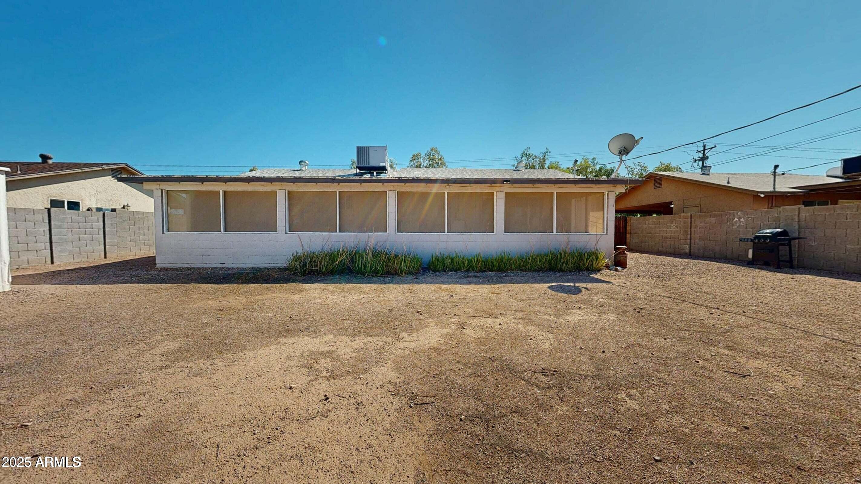 1162 South Ironwood Drive Apache Junction, AZ 85120 - Photo 14 of 14 a front view of a house with a yard and garage