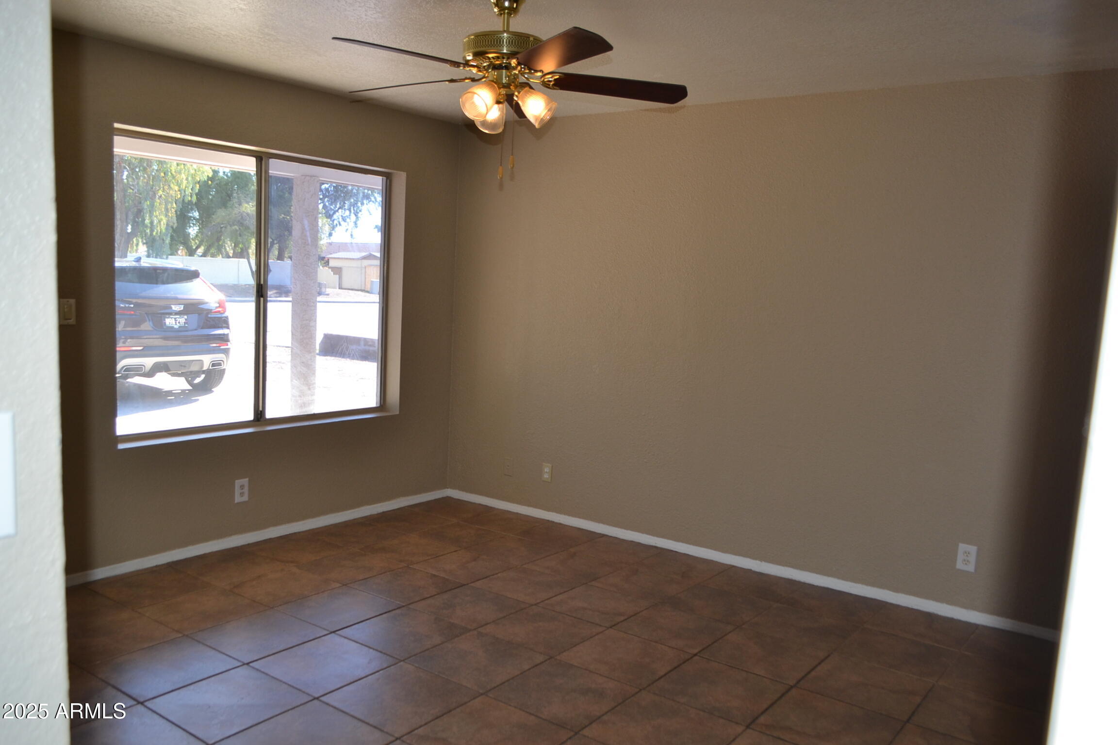 1162 South Ironwood Drive Apache Junction, AZ 85120 - Photo 2 of 14 an empty room with windows and fan