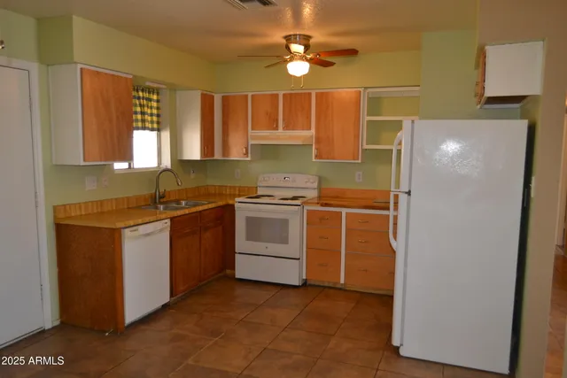 a kitchen with a stove and a refrigerator