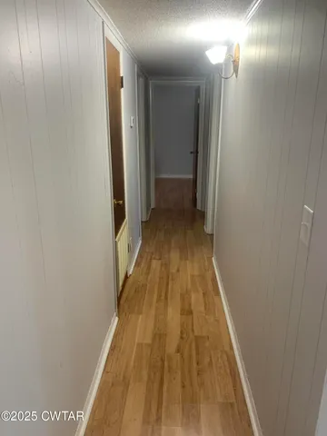 a view of gallery with wooden floor