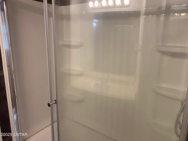 a bathroom with a glass shower door