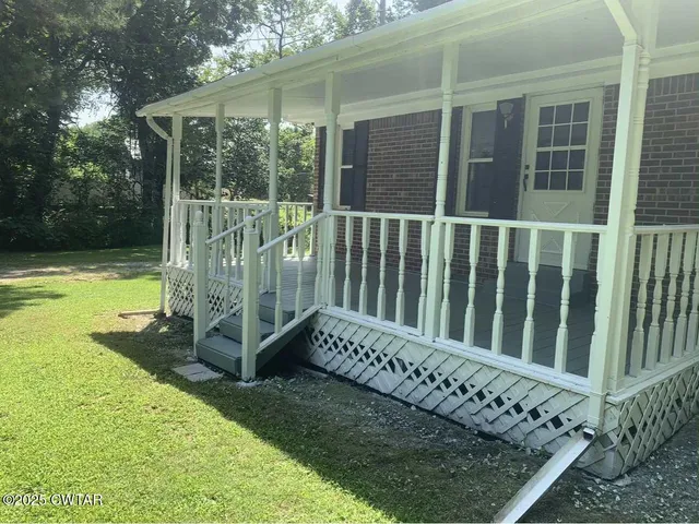 a view of a chair and table in the patio