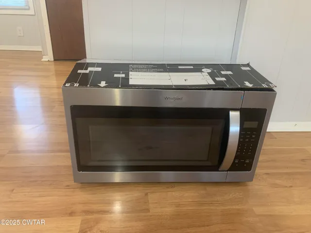 a stove top oven sitting inside of a kitchen