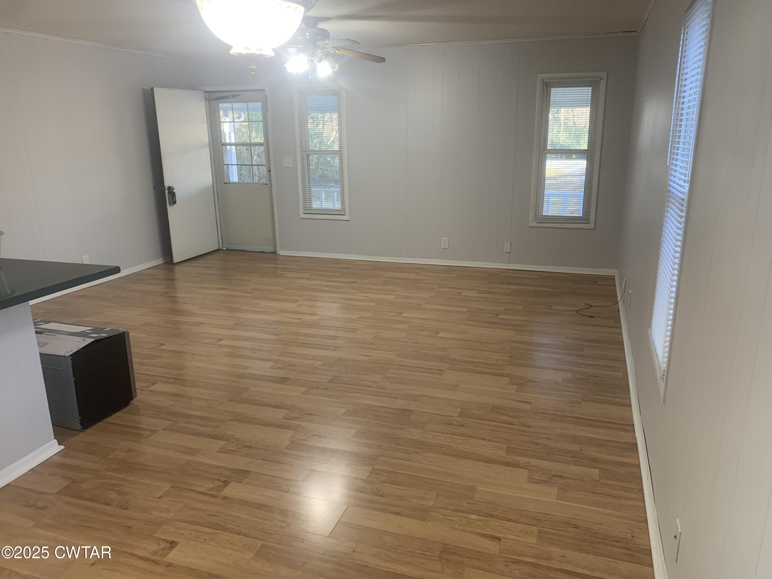 72 Laneview-Concord Road Trenton, TN 38382 - Photo 37 of 39 a view of an empty room with wooden floor and a window