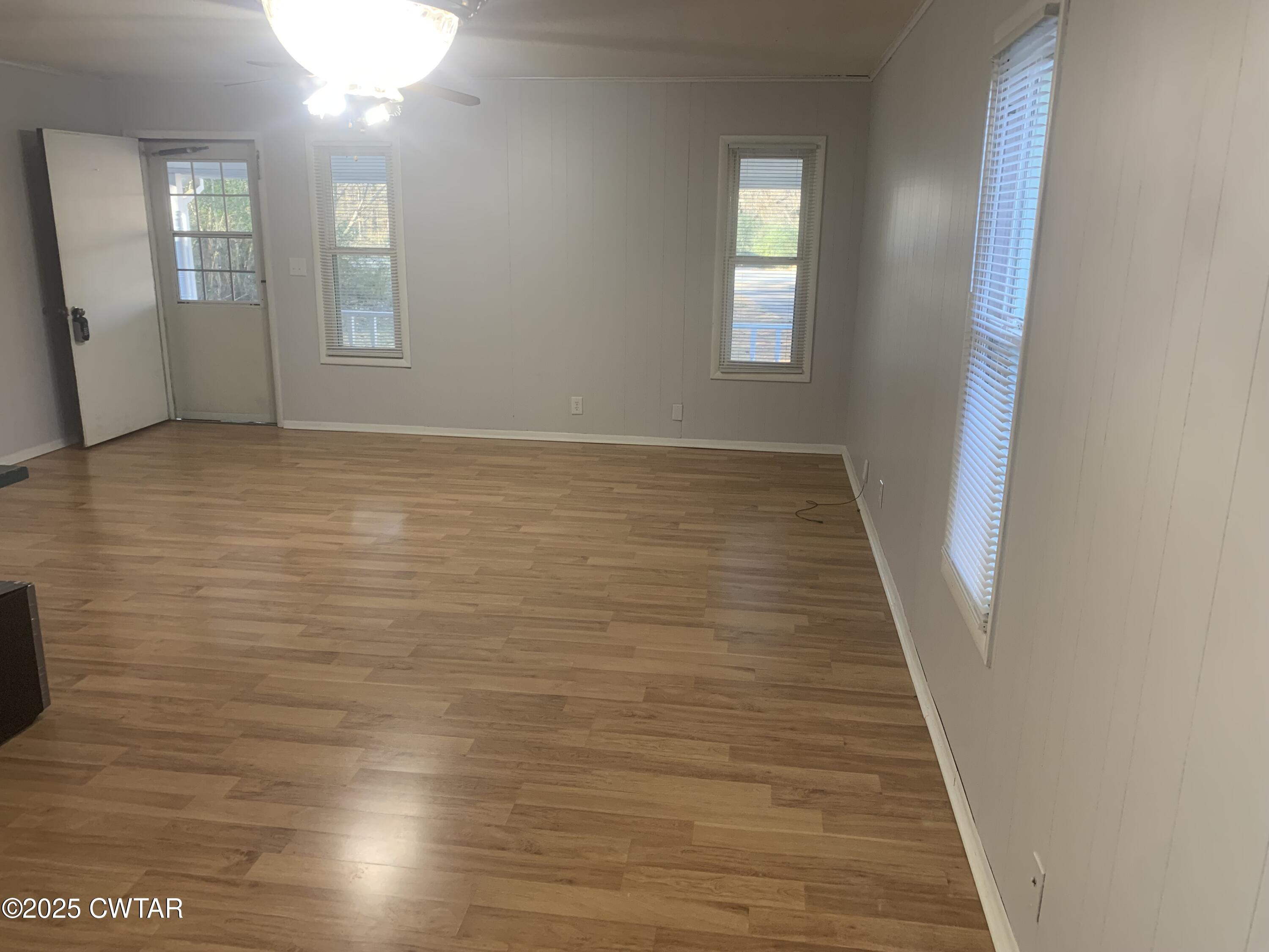72 Laneview-Concord Road Trenton, TN 38382 - Photo 38 of 39 a view of an empty room with wooden floor and a window