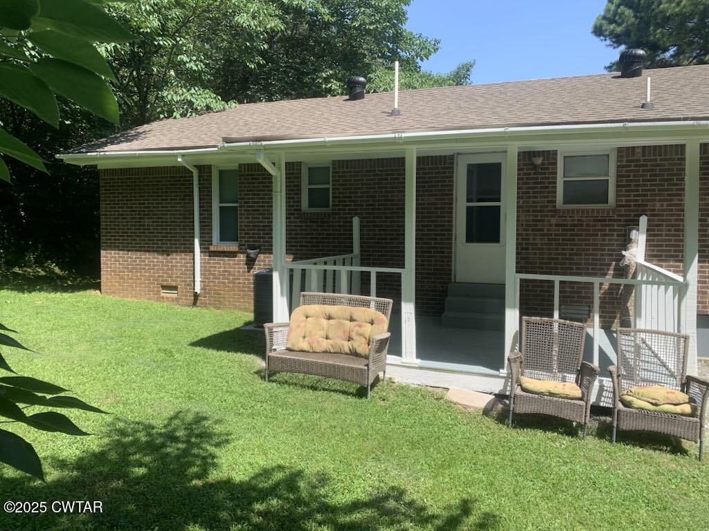 72 Laneview-Concord Road Trenton, TN 38382 - Photo 5 of 39 a front view of a house with a yard table and chairs