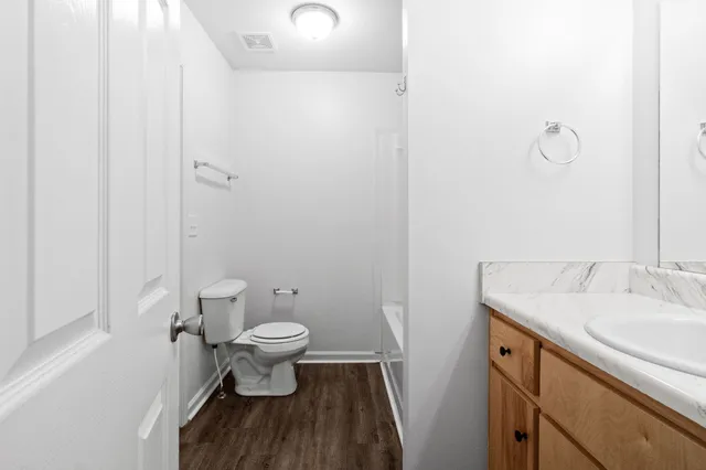 a bathroom with a sink toilet and a mirror
