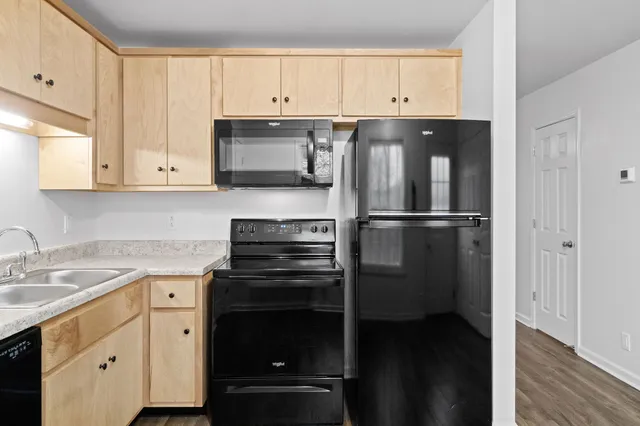 a kitchen with a refrigerator stove and white cabinets