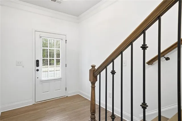 a view of an entryway with wooden floor and door