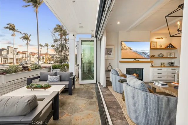 a living room with fireplace furniture and a floor to ceiling window