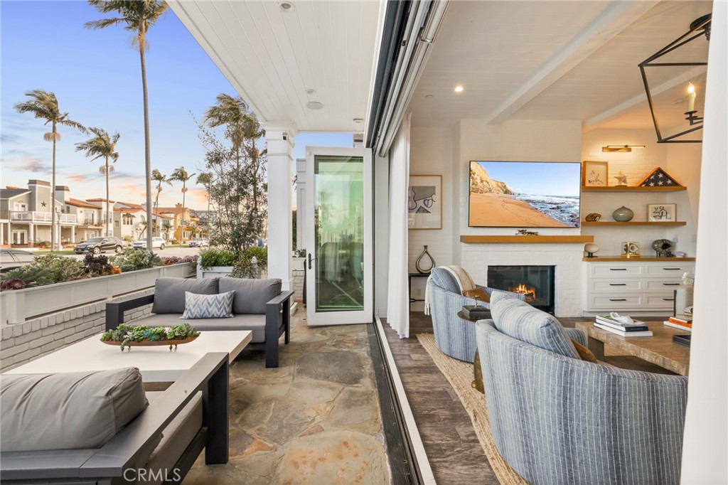 61 The Colonnade Long Beach, CA 90803 - Photo 11 of 49 a living room with fireplace furniture and a floor to ceiling window