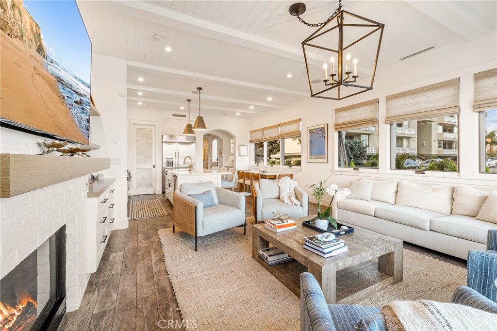 61 The Colonnade Long Beach, CA 90803 - Photo 15 of 49 a living room with furniture a fireplace and a chandelier