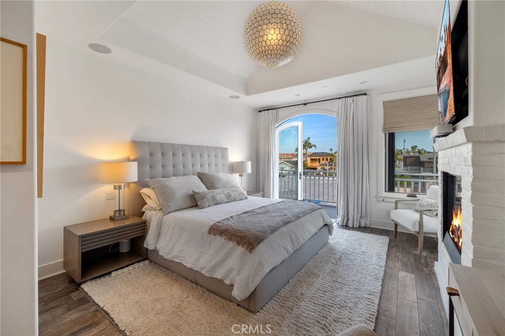 61 The Colonnade Long Beach, CA 90803 - Photo 21 of 49 a bedroom with a large bed and a chandelier