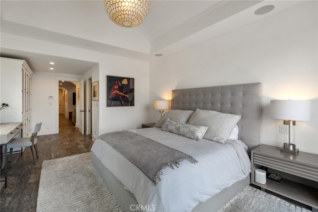 61 The Colonnade Long Beach, CA 90803 - Photo 22 of 49 a bedroom with a bed and a chandelier