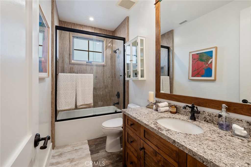 61 The Colonnade Long Beach, CA 90803 - Photo 35 of 49 a bathroom with a granite countertop sink and a mirror
