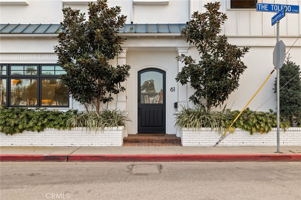 61 The Colonnade Long Beach, CA 90803 - Photo 4 of 49 a front view of a house with a garden