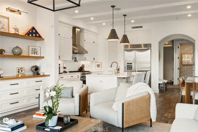 a living room with furniture and a chandelier