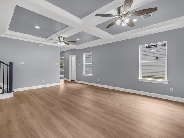 wooden floor in an empty room with a window