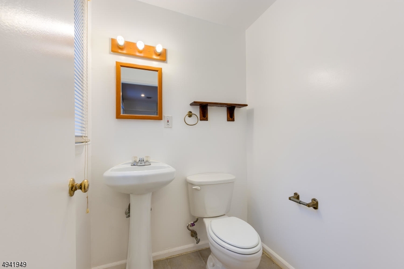857 Cherry Hill Road Princeton, NJ 08540 - Photo 18 of 22 a bathroom with a sink mirror and toilet