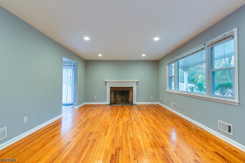 857 Cherry Hill Road Princeton, NJ 08540 - Photo 5 of 22 a view of empty room with wooden floor and fireplace