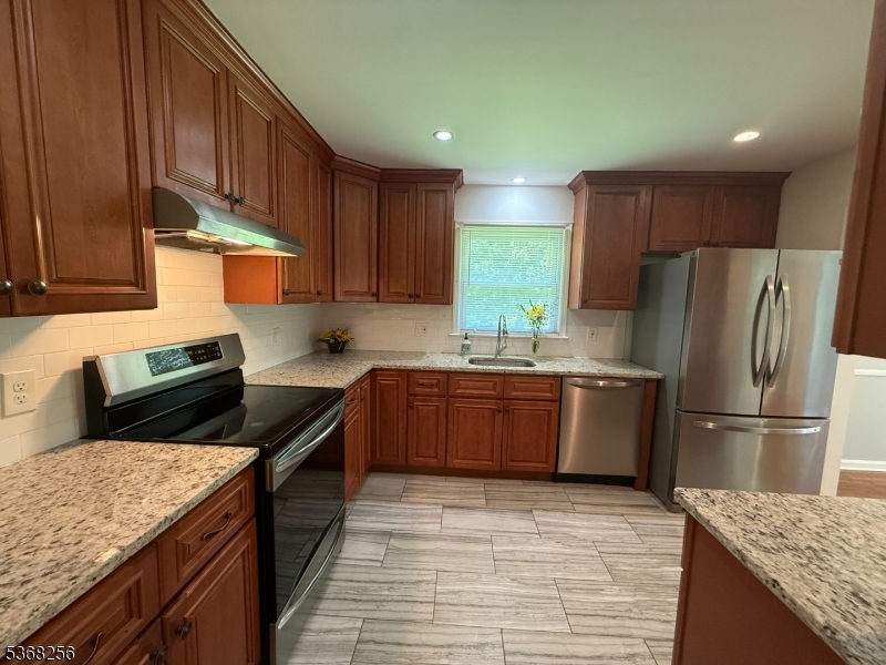 857 Cherry Hill Road Princeton, NJ 08540 - Photo 6 of 22 a kitchen with granite countertop a sink stove and refrigerator