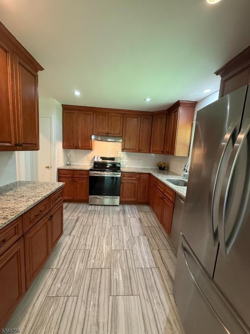 857 Cherry Hill Road Princeton, NJ 08540 - Photo 8 of 22 a kitchen with stainless steel appliances granite countertop a refrigerator a sink dishwasher a stove and wooden cabinets with wooden floor