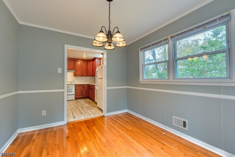 857 Cherry Hill Road Princeton, NJ 08540 - Photo 9 of 22 a bedroom with a bed and a chandelier