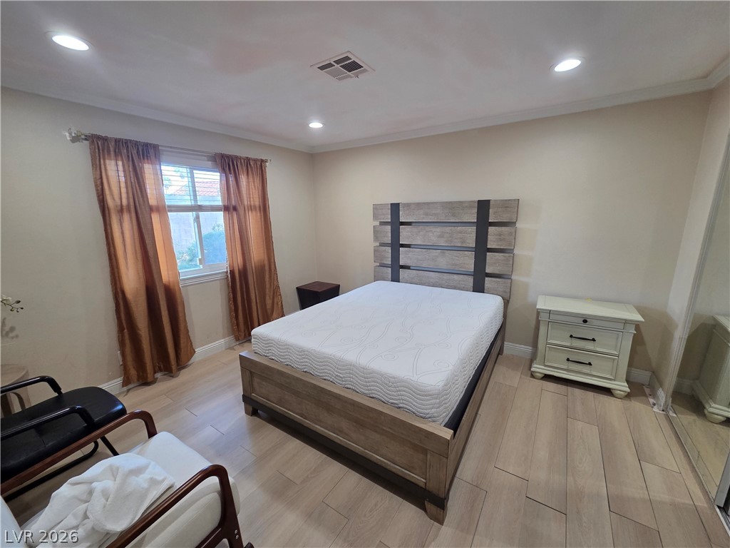 3381 Westwind Road Las Vegas, NV 89146 - Photo 28 of 52 Well-lit sleeping quarters with elegant flooring, providing a calm and inviting atmosphere.