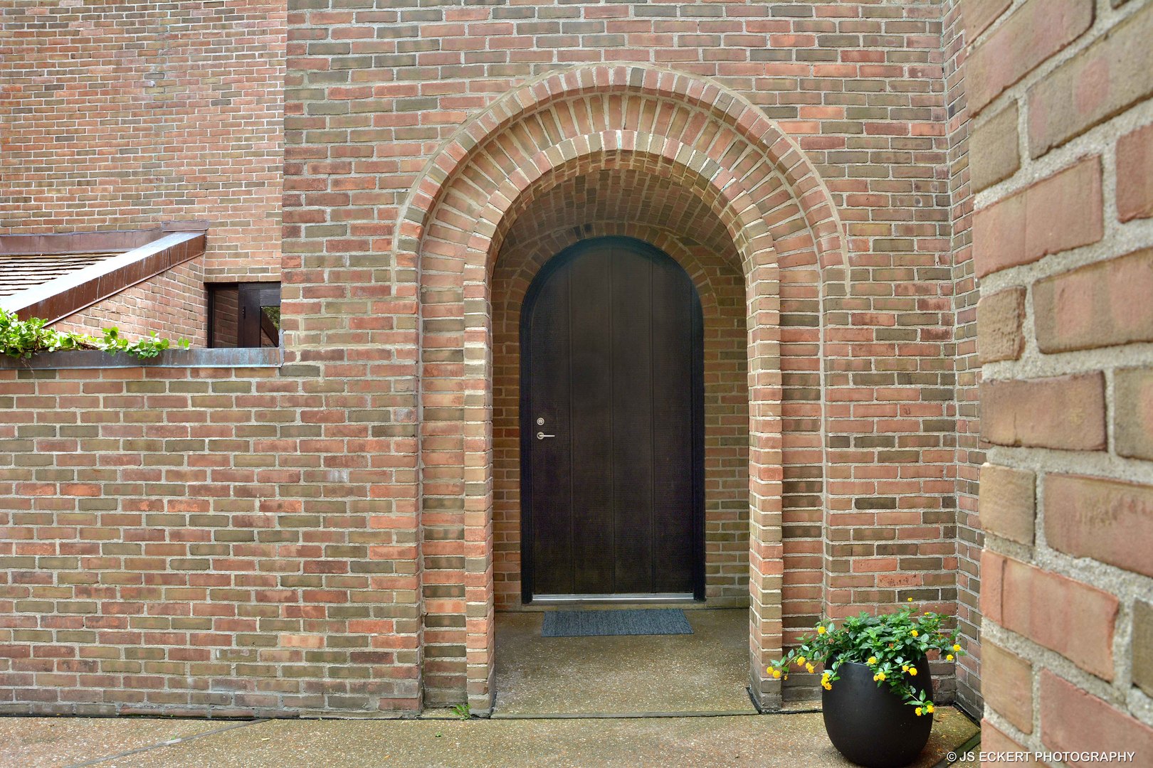 2345 Old Mill Road Lake Forest, IL 60045 - Photo 3 of 73 a close view of a brick house with potted plants