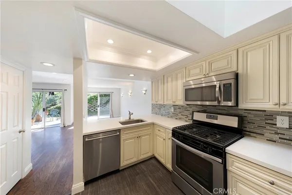 a kitchen with a sink stove top oven and cabinets