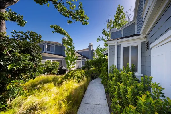 a view of a house with potted plants