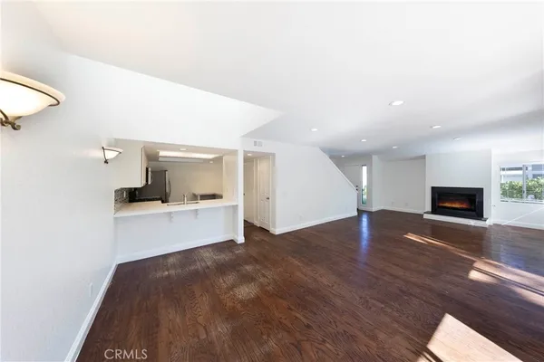 a view of kitchen and hall with wooden floor