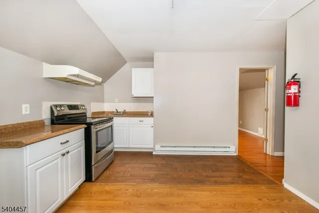 a kitchen with granite countertop a sink and a stove top oven